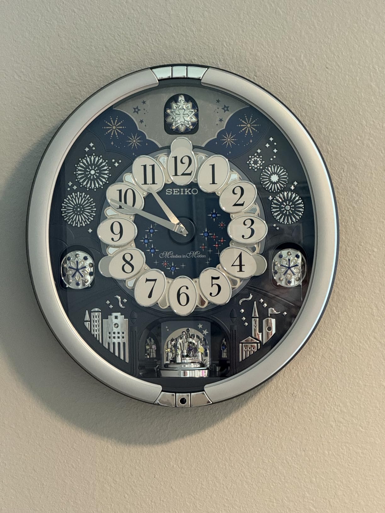 Seiko QXM379SRH 18 Melodies in Motion Rotating Pendulum Wall Clock, Silver Stars customer photo 2